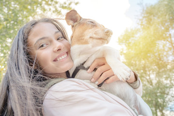 dog jack russell terrier and young girl owner happy together close up