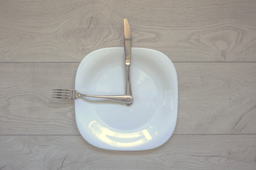 mealtime, plate, knife and fork in the shape of a clock, healthy food concept