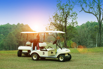 Golfcar in beautiful golf course in the evening golf course with sunshine