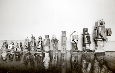 vintage toy robots from small to big in solarized monochrome