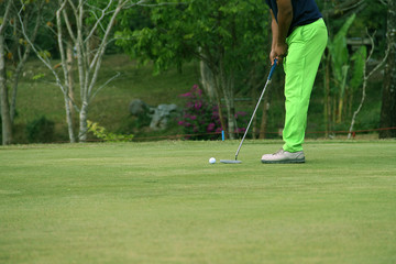Blurred golfers are patting golf in the evening golf course in Thailand
