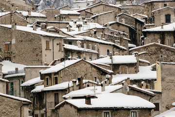 beautiful quaint village in the mountains on the snow in winter - concept of tourism in the villages and the quiet and quality of life - lovers of nature and Italian architecture