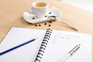 pencil, pen, notebook, cup of hot coffee