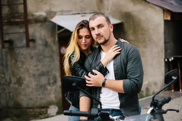 Couple on motorbike near old building
