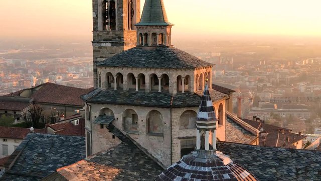 One of the beautiful city in Italy Citta Alta of Bergamo. Lombardia, evening sunset and landscape on the old city with Cathedral, clock towers and the Po Valley, 4k footage video.