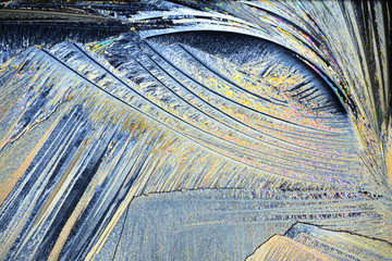 Photo through a microscope of crystals grown from the melt of sulfo-salicylic acid. Polarized light...