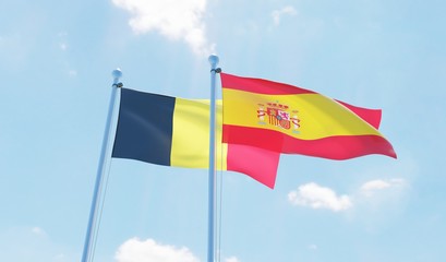 Spain and Belgium, two flags waving against blue sky. 3d image