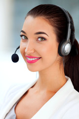 Closeup shot of young pretty call center worker with headset