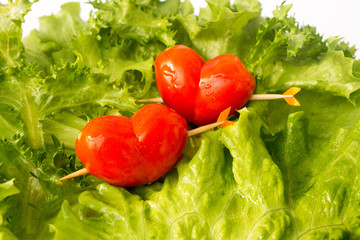 two red tomato cherry on the green iceberg salad and lemon slidce