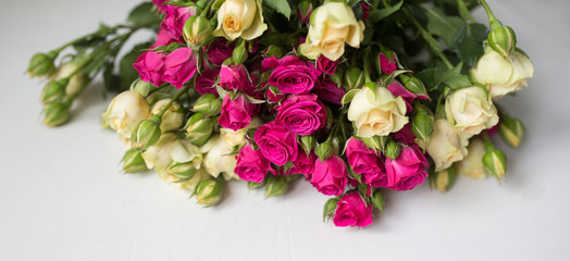 Pink and white rose bush collected in a bouquet. Beautiful floristry for weddings, holidays. Floral decoration of flowers. Panorama background.
