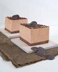 Pieces of chocolate cheesecake, decorate by chocolate slice on white background