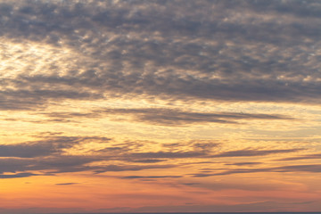 Beautiful background of a pink yellow sunset sky with clouds. Beauty of nature.
