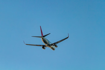 Flying passenger plane on blue sky background