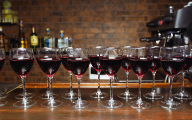 red wine in glasses on the bar