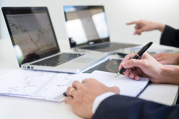 Fototapeta premium Business Team trader or broker Investment Entrepreneur colleagues working discussing and analysis graph stock market trading with forex chart data, financial, selling and buying concept