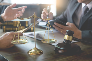 business people and lawyers discussing contract papers sitting at the table. Concepts of law, advice, legal services