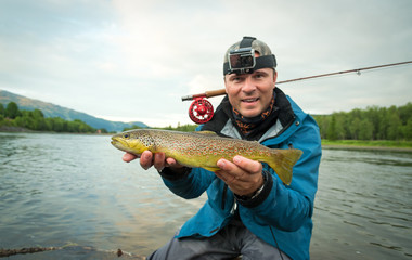 Brown trout fly fishing happiness © Piotr Wawrzyniuk