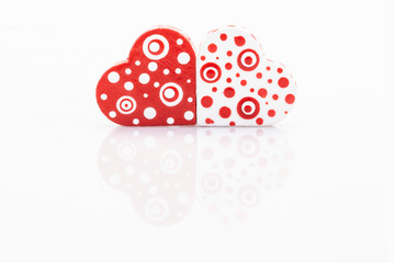 small red hearts on white with reflection