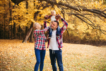 Little cute son playing with parents in forest