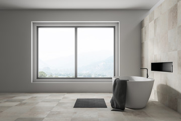 Side view of beige bathroom with tub