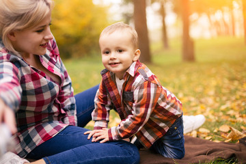 Fototapeta na wymiar Family on weekend. Mother father and son in park