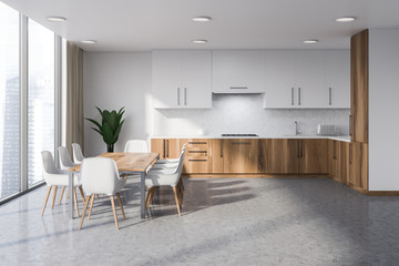 White and wooden kitchen with table