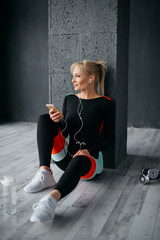happy sporty woman listening to music on headphones