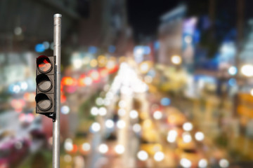 Traffic light with abstract blurred traffic jam background.