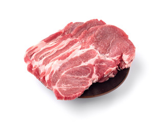 pork lean steaks on brown porcelain plate isolated on white background