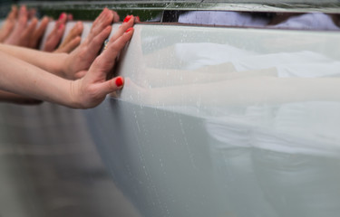 women's hands on the car