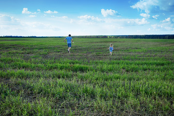 Father and daughter flying a kite.