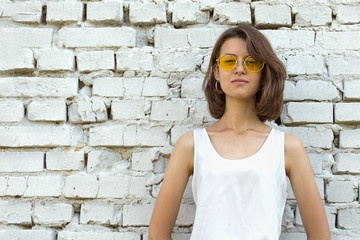 Serious Teenage girl in yellow glasses. Copy space.