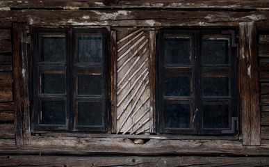 Fototapeta na wymiar Rustic old peasant house with wooden windows