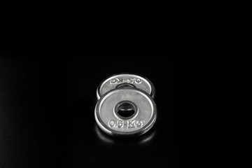 Extra Weight for Dumbbells on Black Background