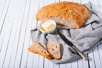 brown bread and butter, old knife on white wood table