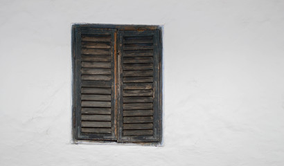 Rustic old peasant house with wooden windows