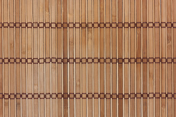 Beige bamboo mat with dark threads. Texture for background and design.