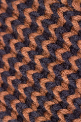Knitting. Background knitted texture. Bright knitting needles. Black and brown woolen yarn for knitting.