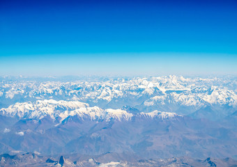 Obraz premium Mountains earth from aircraft under blue sky