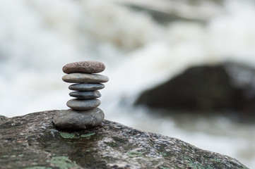 Closeup of stone balance on rock in border river