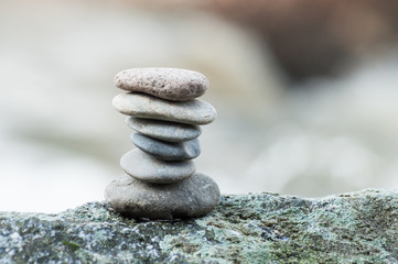 Closeup of stone balance on rock in border river