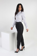 Business woman in pants and shirt on a white background. Office and business style. Studio photo.