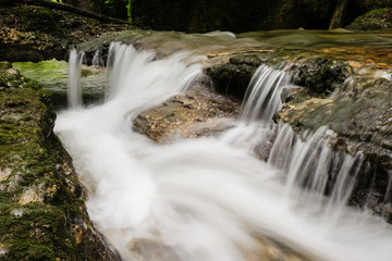 Water runs down a small stream, long exposure