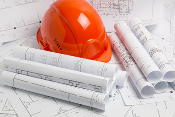 Paper architectural drawings, blueprint  and helmet. Engineering blueprint