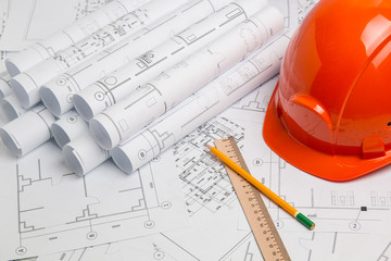 Paper architectural drawings, blueprint, pencil, ruler and helmet. Engineering blueprint