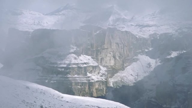 Snowy peaks of the Dolomite in the fog