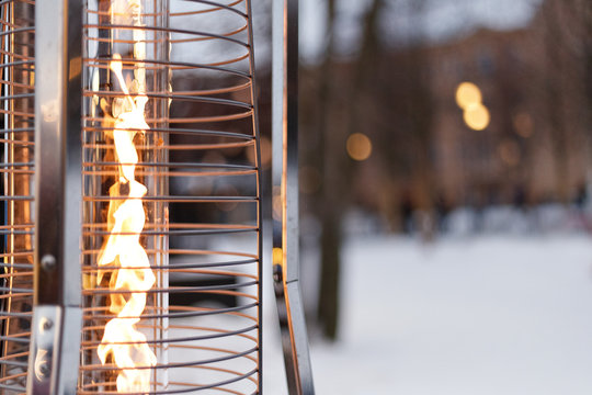 fire, warm, warms fire on the background of the city, gas lampa in a street