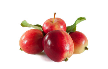 Group of four red chinese apples with green leaves isolated on white