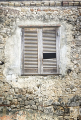 Fototapeta na wymiar Old wooden window on a gray brick wall with copy space
