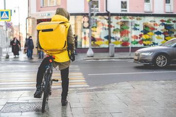 courier on bike deliever tasty food  in city streets b